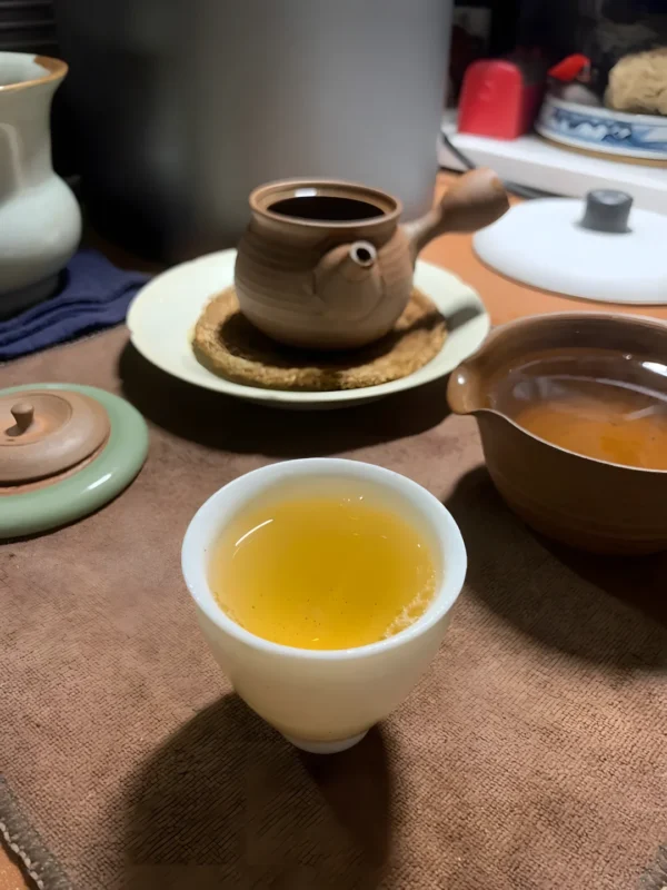 Golden Tie Guan Yin Oolong Tea in a ceramic cup, offering smooth flavor, floral aroma, and calming health benefits