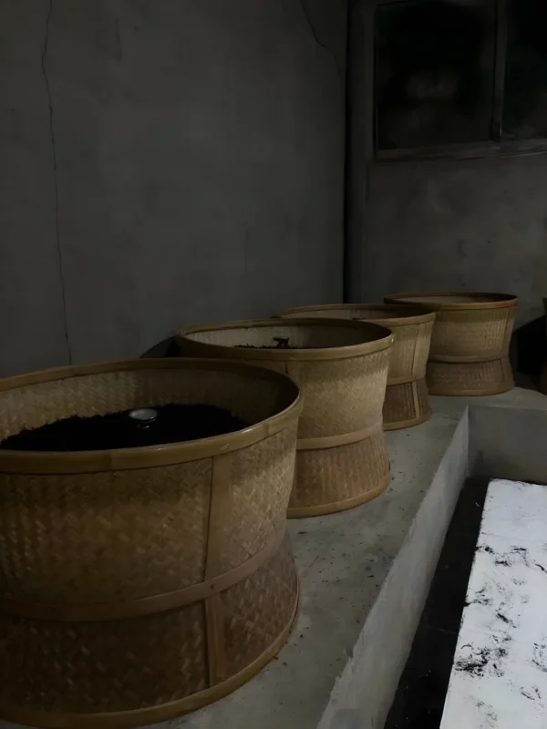 Bamboo baskets for final roasting stage, enriching catechins and flavonoids for better health benefits.