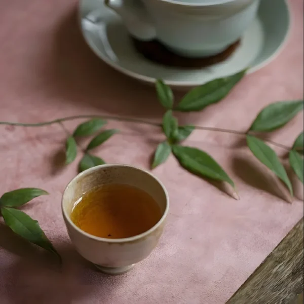 Chinese black tea in a ceramic cup, a pure leaf low caffeine vitality tea for a calming and energizing experience.