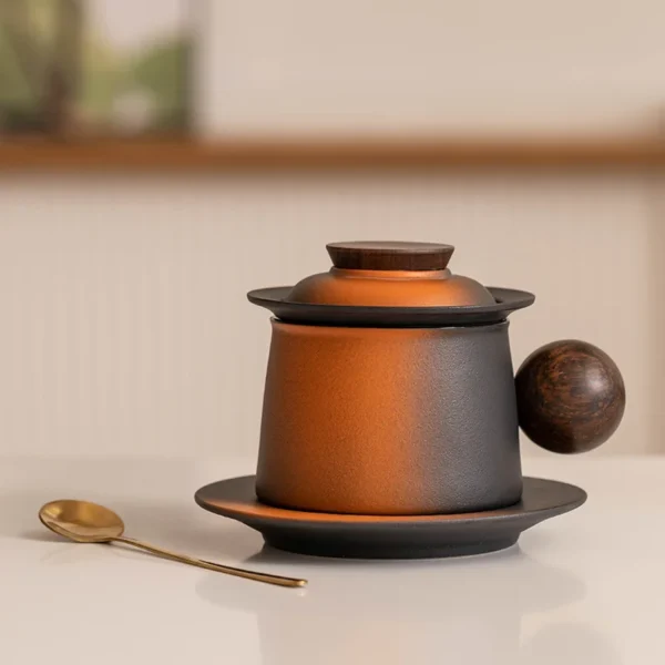 Amber Black Ceramic Infuser Tea Mug with Lid, Saucer & Spoon for brews tea mug, sophisticated and elegant for tea lovers.