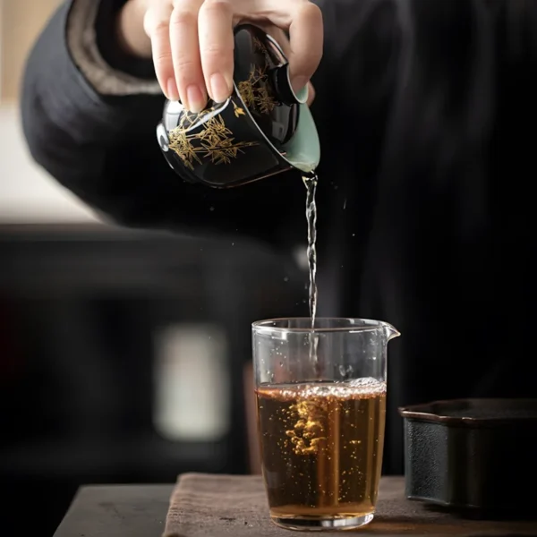 Pouring tea from a gold flowers gaiwan into a glass fair cup, part of a China porcelain tea set vintage collection for tea lovers.