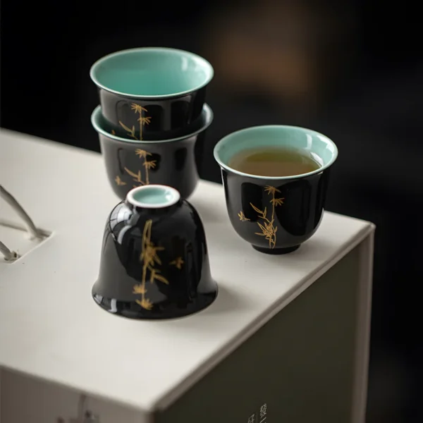 3D ceramic tea cups with ceramics tea dust and frost blue glaze dips, featuring elegant gold bamboo patterns, displayed on a box.