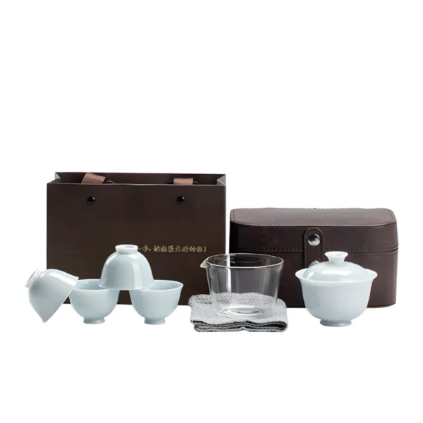 Chinese ceremonial tea set with blue celadon gaiwan, tea cups, and a travel case.