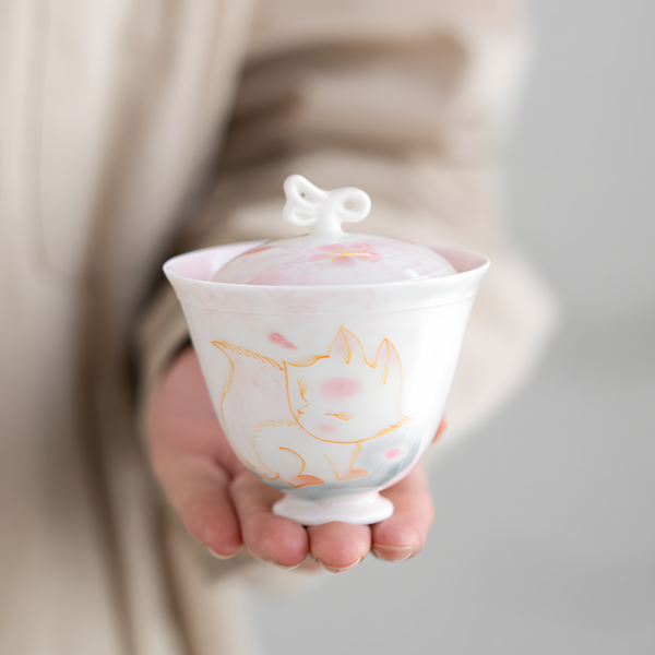 Hand holding the cutest fox gaiwan set, a porcelain tea set for adults, also suitable as a princess tea set.