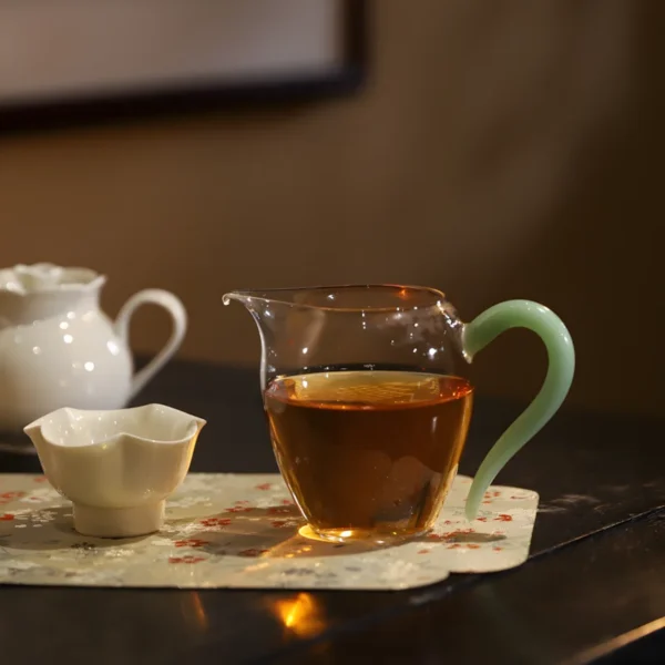 Photo of tea cup featuring transparent tea cups, ideal as Chinese cups for tea with a green handle, perfect green tea cup.