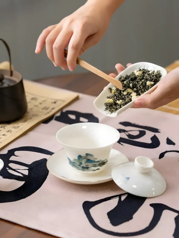 A person preparing Jasmine Jade Sprout Tea, a sprouts green tea with jasmine flower tea for a relaxing herbal tea experience.