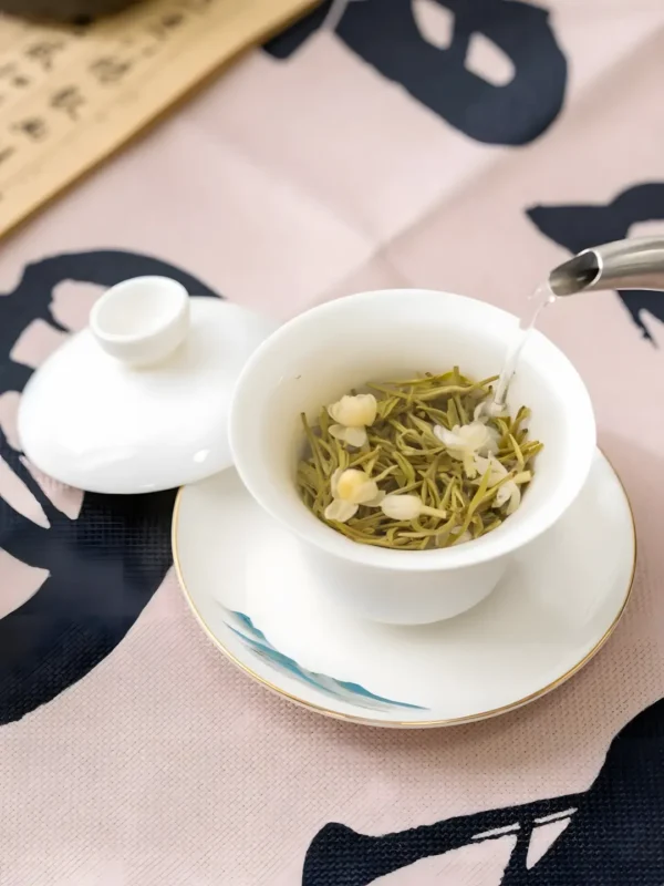 Pouring hot water into Jasmine Jade Sprout Tea, a sprouts green tea, perfectly paired with jasmine Asian cuisine.