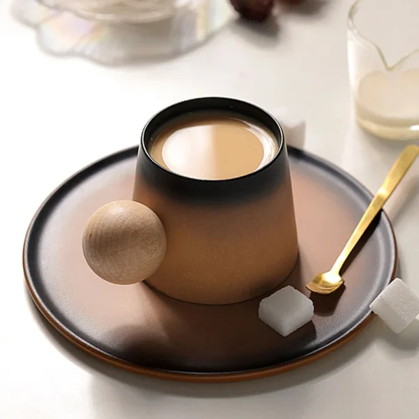 Tall ceramic coffee cup with a footed base and wooden handle, part of the clay coffee collective sensory cup collection.