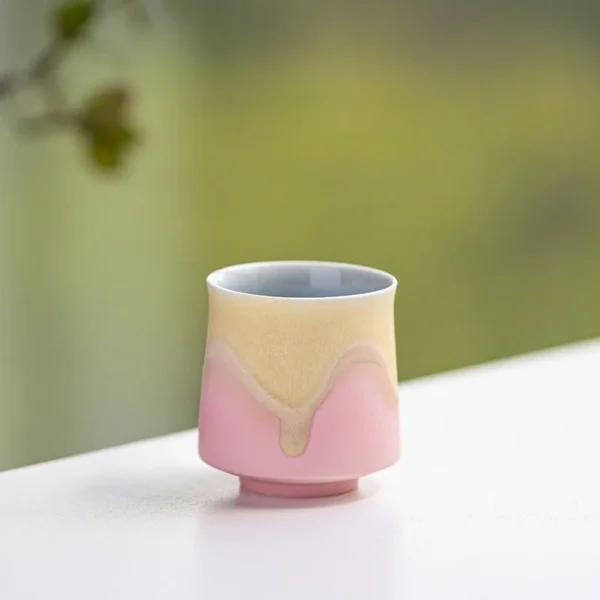 A handcrafted ceramic tea cup with minimalist design and pink pastel glaze, ideal for relaxing tea moments or as a gift.