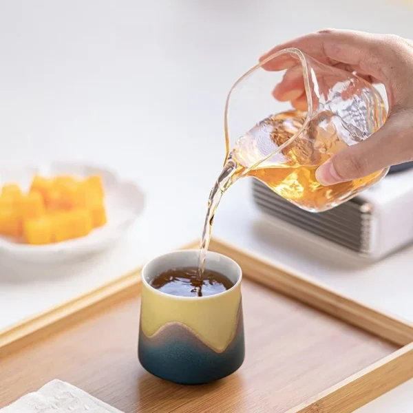 A 130ml ceramic cup with an ergonomic design, perfect for tea brewing and coffee serving, blending comfort with functionality.