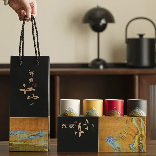 Artistic ceramic gift bag with mountain-inspired design, vibrant cups, and elegant packaging for special occasions and collectors.