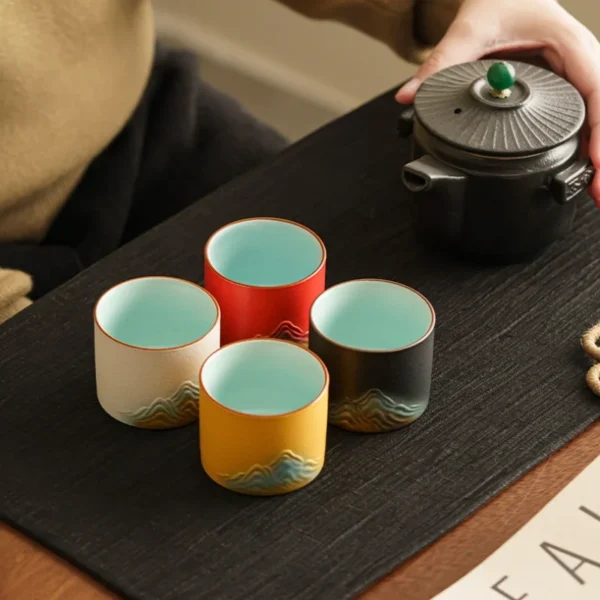 Vibrant ceramic cups with mountain-inspired designs and soothing interiors, perfect for tea, coffee, and beverage lovers.