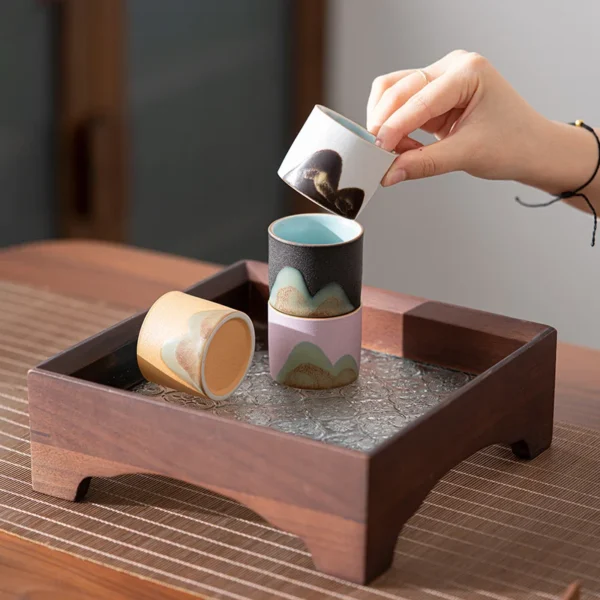 Handcrafted stackable ceramic cups with mountain-inspired details, perfect for tea lovers and practical everyday use.