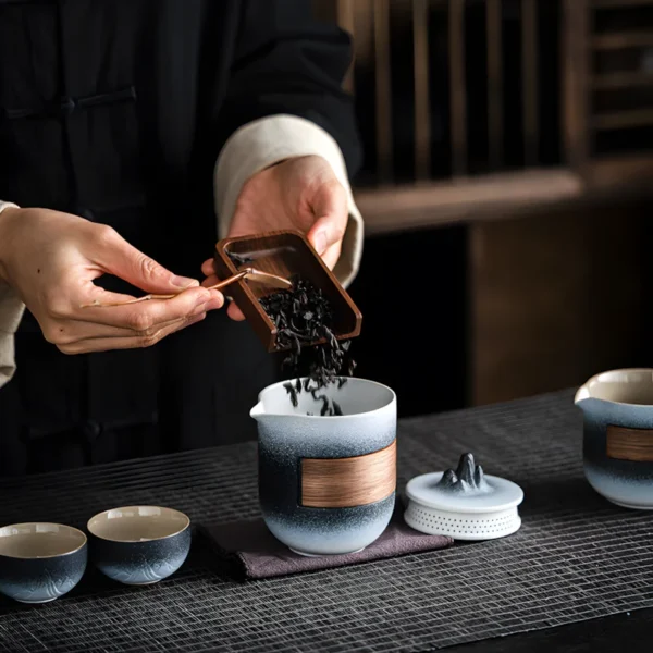 Gongfu china tea set for adults, with outdoor tea table set, teacups, and tea being poured during a tea party setting.