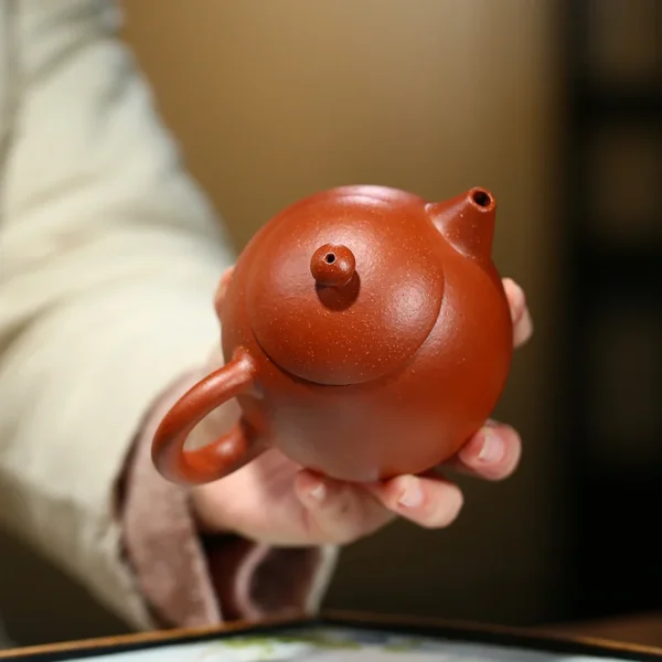 Experience the best Yixing purple clay teapot, a bamboo-engraved brewing tool designed for aromatic tea enthusiasts and collectors.