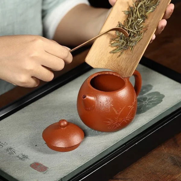 This handcrafted Yixing teapot features a wide-mouth design for easy tea leaf placement, made from authentic purple clay for tea lovers.