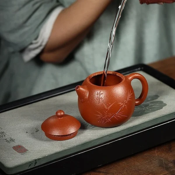 This authentic Yixing purple clay teapot features a precision pouring spout, ensuring smooth water flow for perfect tea brewing.